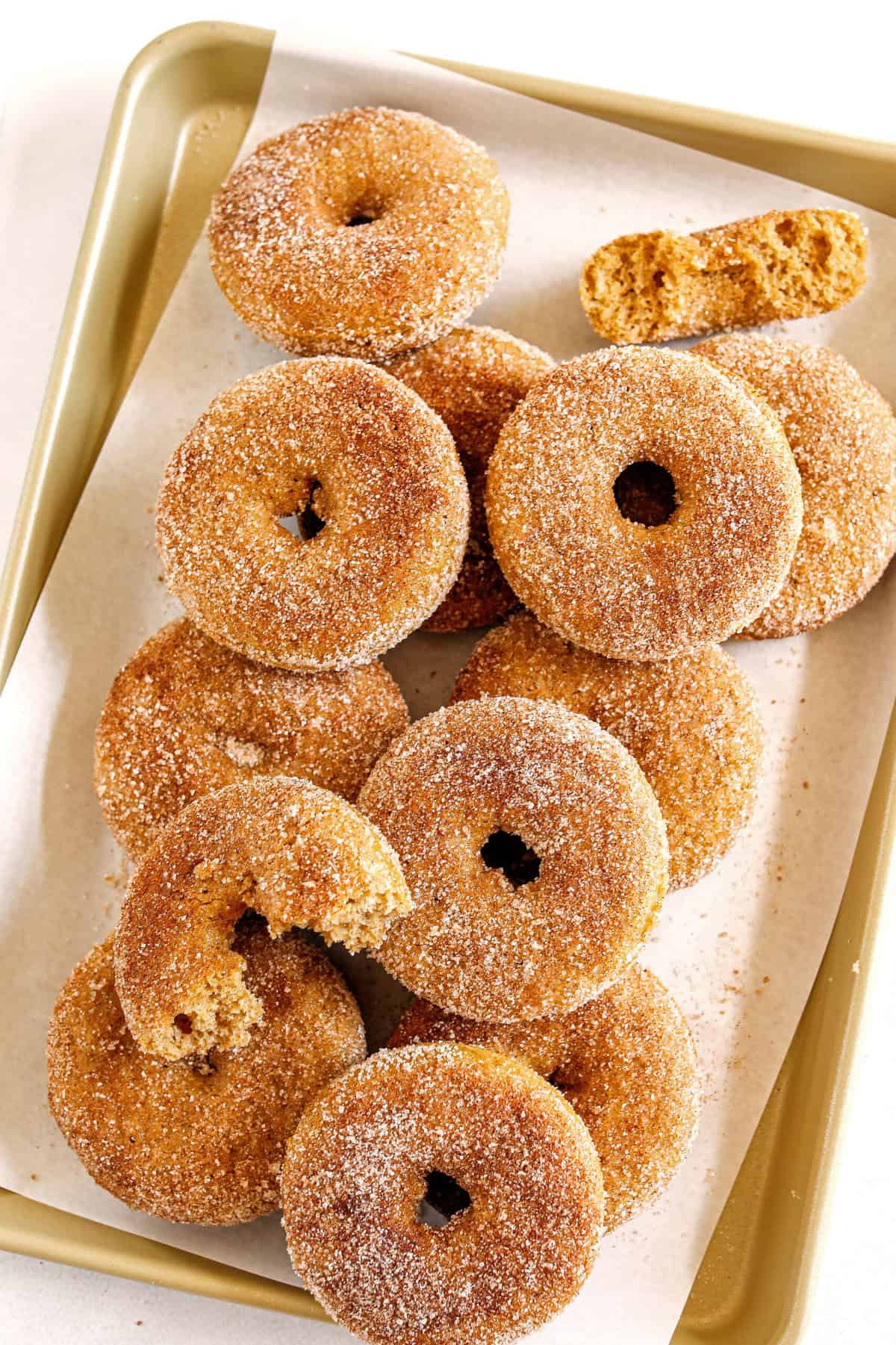 Soft Baked Apple Cider Donuts made healthier with whole wheat flour, applesauce and Greek yogurt for the perfect fall treat that comes together in just 20 minutes! Loaded with warm spices and coated with cinnamon and sugar!