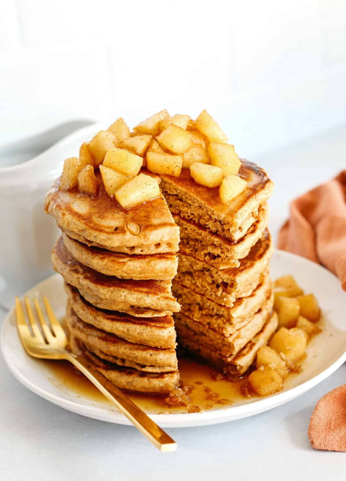 Light and fluffy Apple Cinnamon Pancakes made healthier with whole wheat flour, applesauce in place of oil and zero butter or refined sugar! Topped with warm spiced apples and drizzled with maple syrup!