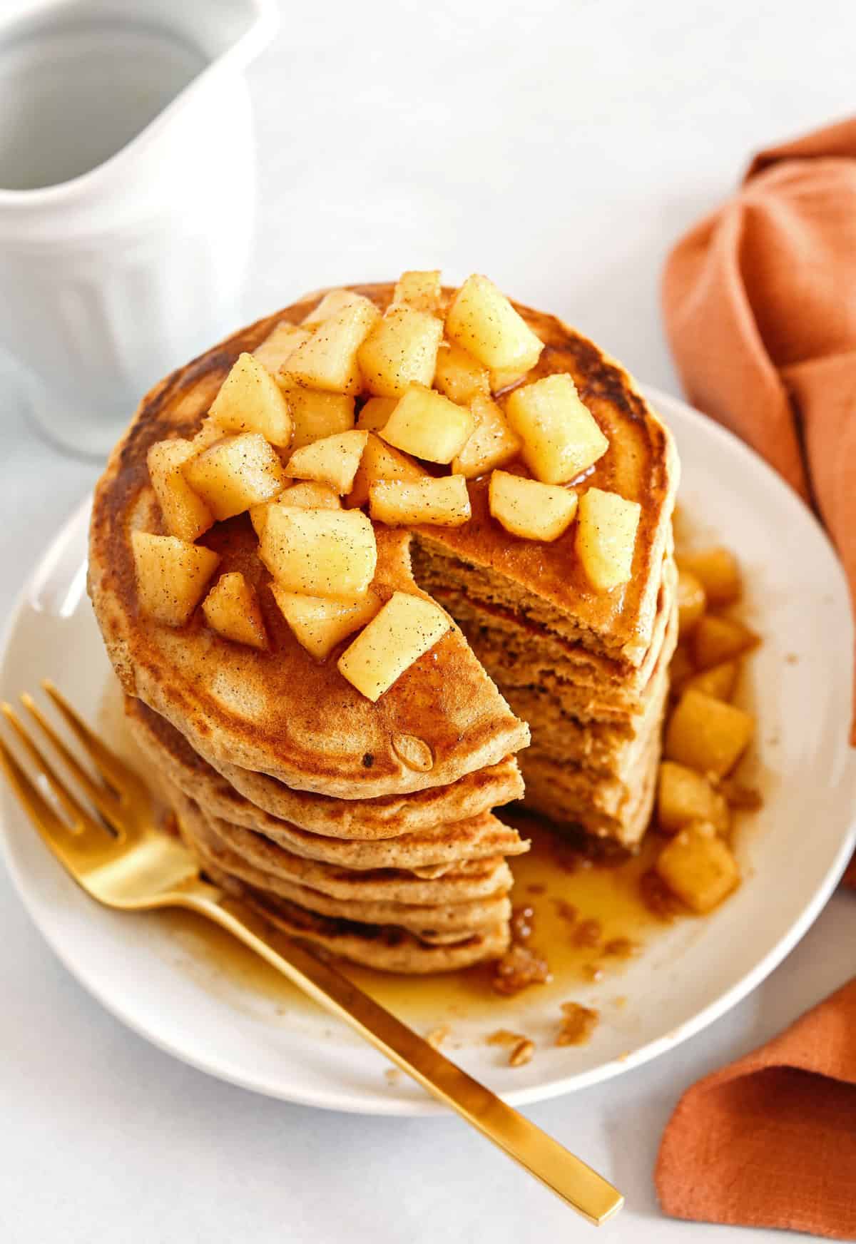 Light and fluffy Apple Cinnamon Pancakes made healthier with whole wheat flour, applesauce in place of oil and zero butter or refined sugar! Topped with warm spiced apples and drizzled with maple syrup!