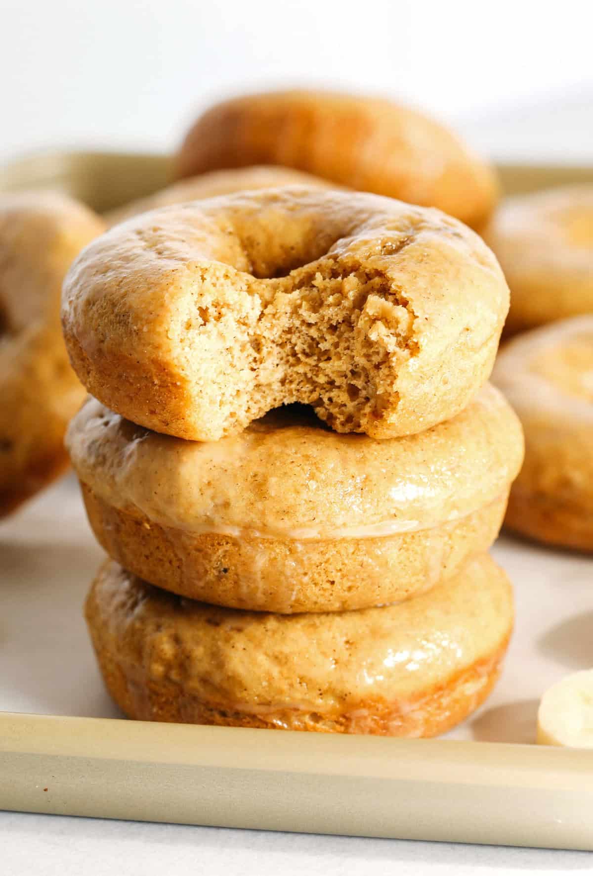 These Baked Banana Bread Donuts are soft, cake-like and made healthier with whole wheat flour, applesauce and zero refined sugar for the perfect morning treat that comes together in just 20 minutes! Such a great way to use up those overripe bananas!