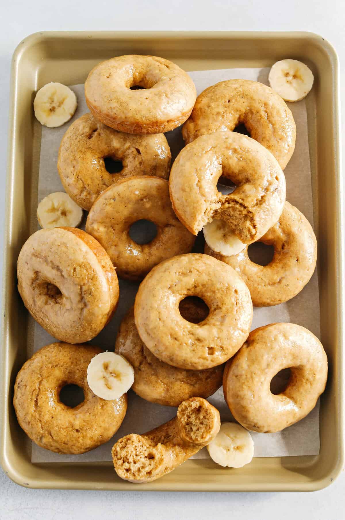 These Baked Banana Bread Donuts are soft, cake-like and made healthier with whole wheat flour, applesauce and zero refined sugar for the perfect morning treat that comes together in just 20 minutes! Such a great way to use up those overripe bananas!