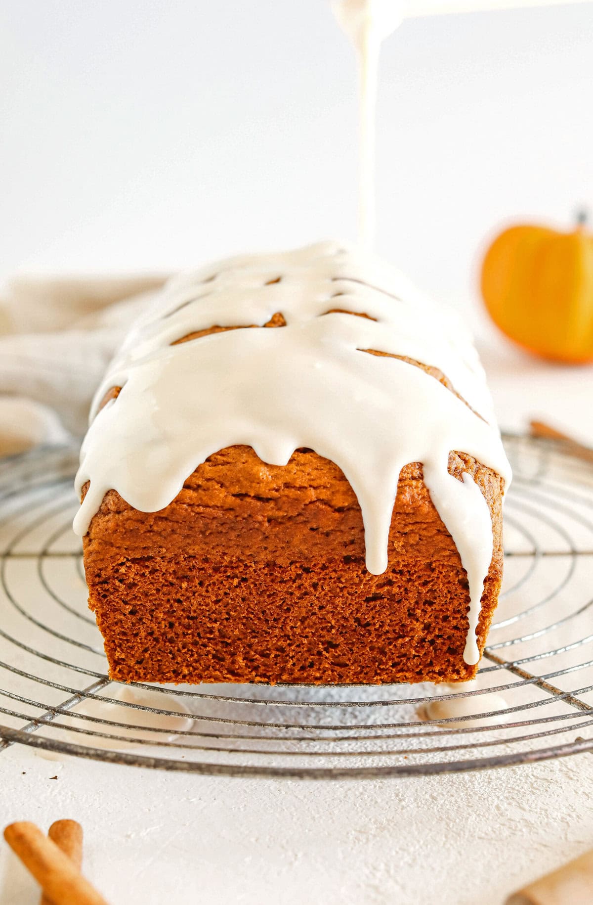 The BEST Healthy Pumpkin Bread recipe that is moist, loaded with pumpkin flavor and made without any butter or refined sugar! Topped with a delicious maple cream cheese glaze for the perfect fall treat this season!