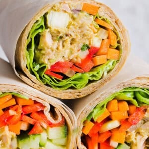 The BEST Spicy Tuna Avocado Wrap made with canned tuna, sriracha, crisp veggies and avocado that easily comes together in just 5 minutes! Delicious high-protein snack with crackers or served in a wrap for a healthy lunch.