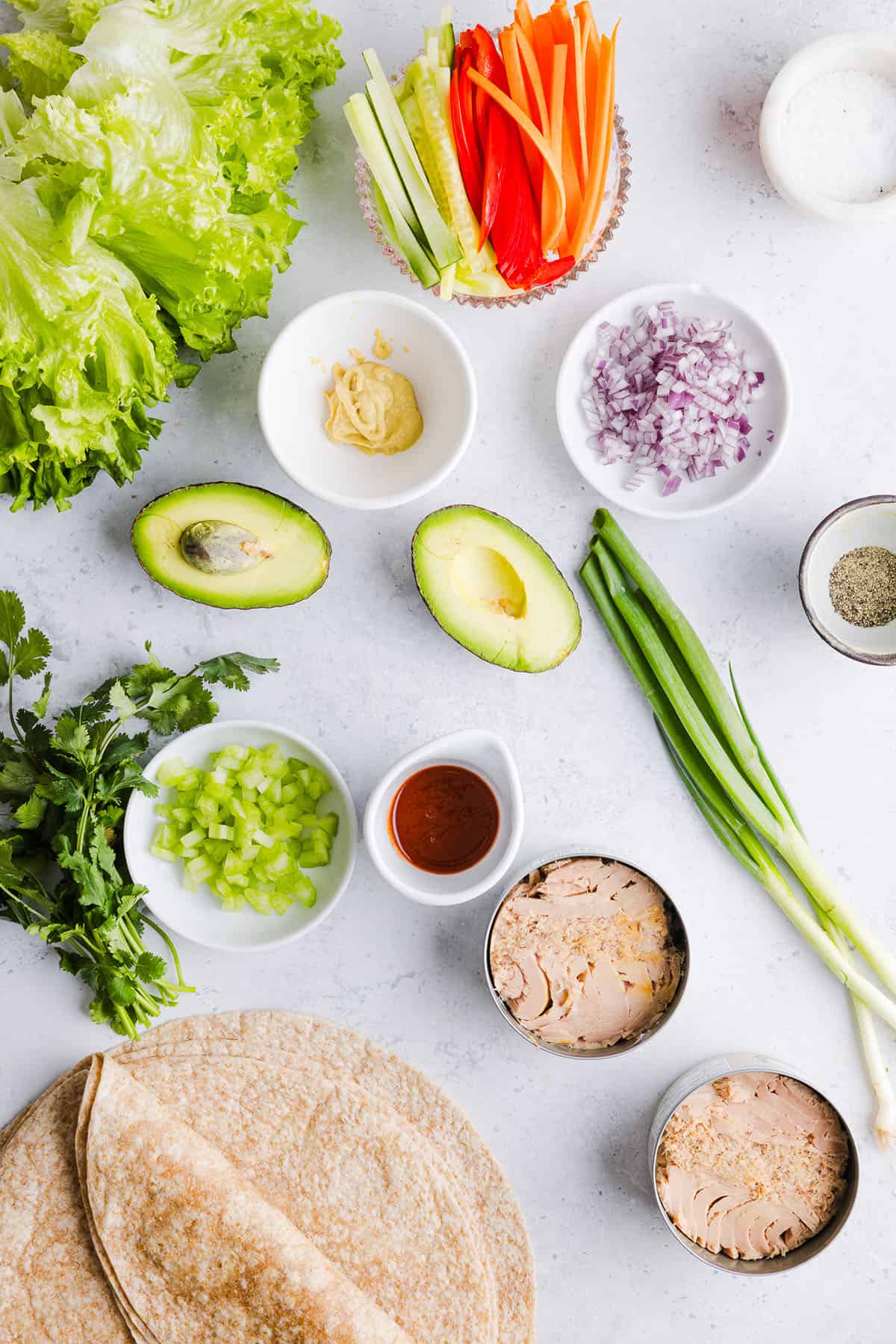 The BEST Spicy Tuna Avocado Wrap made with canned tuna, sriracha, crisp veggies and avocado that easily comes together in just 5 minutes! Delicious high-protein snack with crackers or served in a wrap for a healthy lunch.