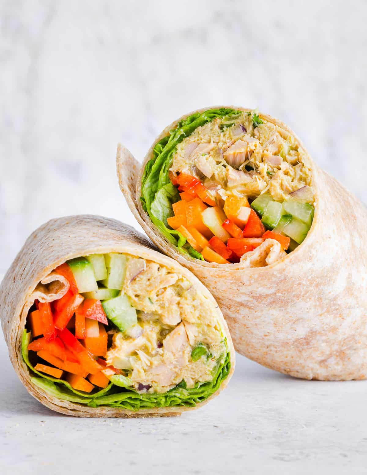 The BEST Spicy Tuna Avocado Wrap made with canned tuna, sriracha, crisp veggies and avocado that easily comes together in just 5 minutes! Delicious high-protein snack with crackers or served in a wrap for a healthy lunch.