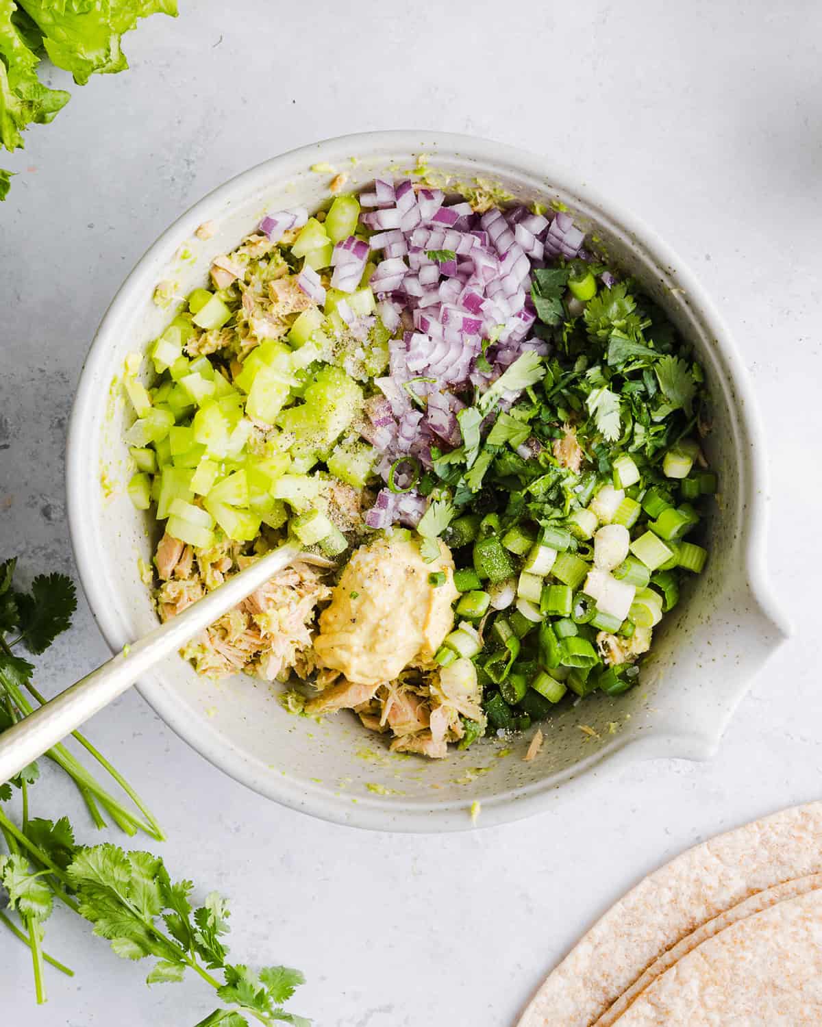 The BEST Spicy Tuna Avocado Wrap made with canned tuna, sriracha, crisp veggies and avocado that easily comes together in just 5 minutes! Delicious high-protein snack with crackers or served in a wrap for a healthy lunch.