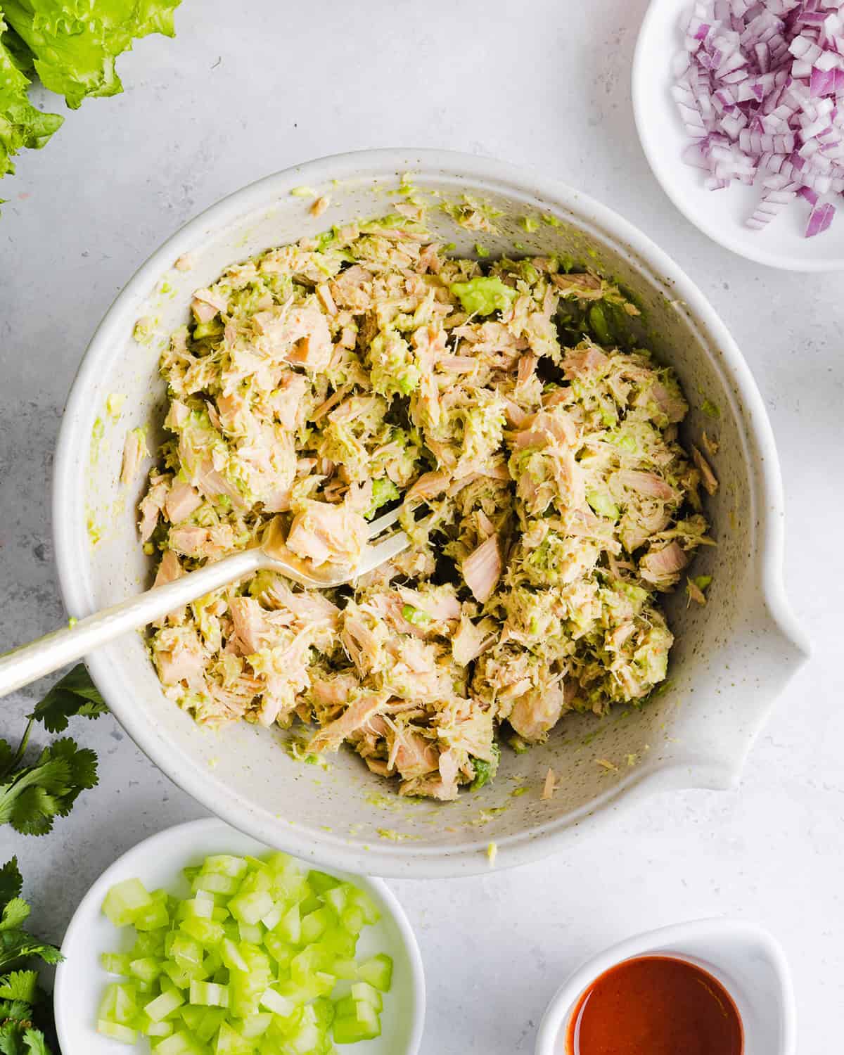The BEST Spicy Tuna Avocado Wrap made with canned tuna, sriracha, crisp veggies and avocado that easily comes together in just 5 minutes! Delicious high-protein snack with crackers or served in a wrap for a healthy lunch.