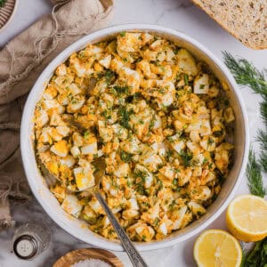 This Healthy Egg Salad is packed with protein, fresh flavors and made healthier with Greek yogurt in place of mayo! Enjoy this on a sandwich, lettuce wrap, with crackers or straight from the bowl!