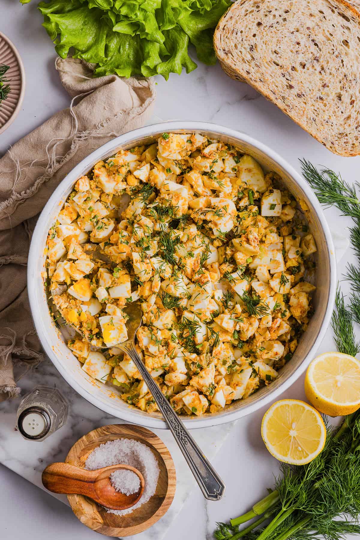 This Healthy Egg Salad is packed with protein, fresh flavors and made healthier with Greek yogurt in place of mayo! Enjoy this on a sandwich, lettuce wrap, with crackers or straight from the bowl!